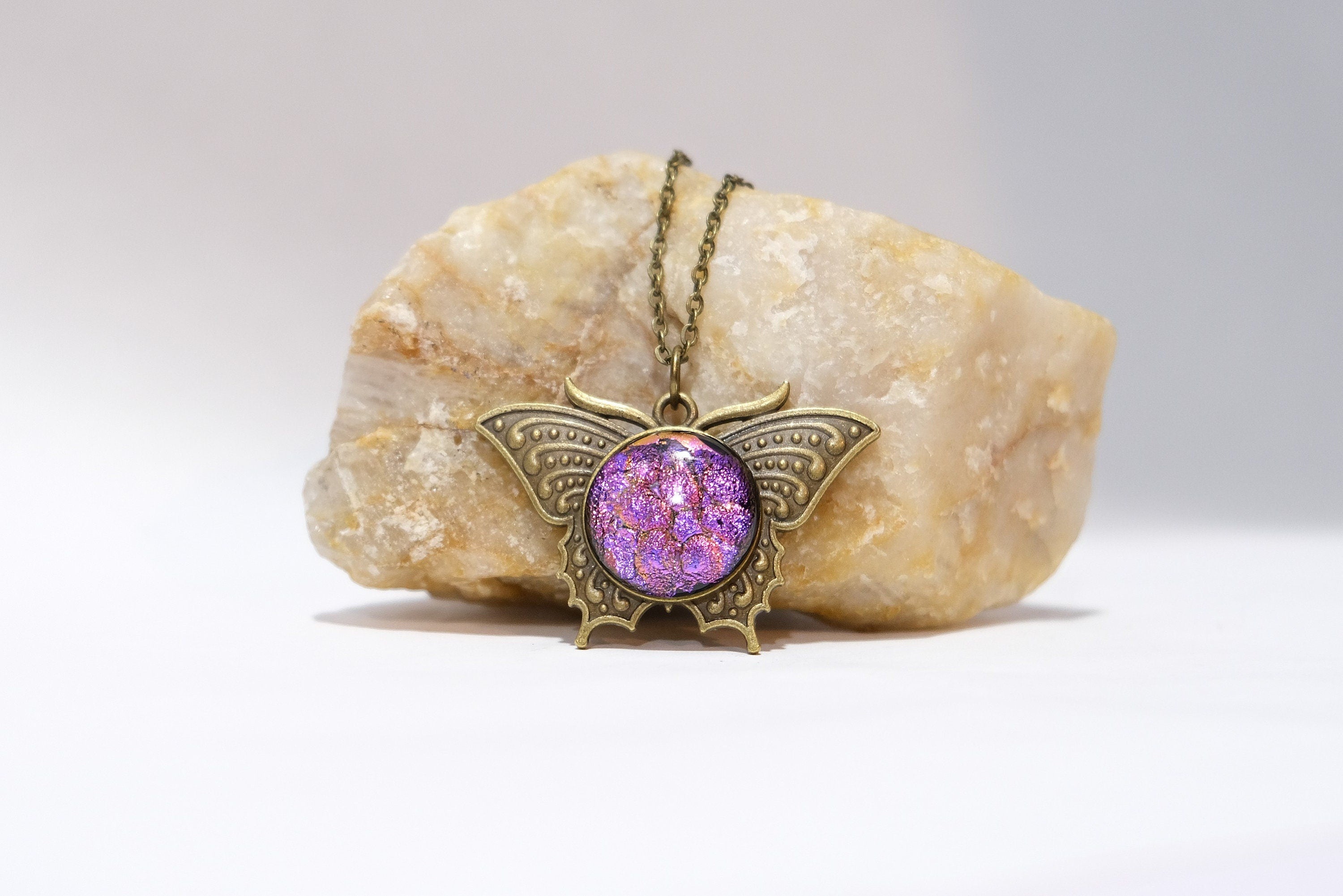 Butterfly pendant necklace, brass tone with pink purple dichroic fused glass center stone on a 20 inch brass tone chain seeds glassworks seedsglassworks