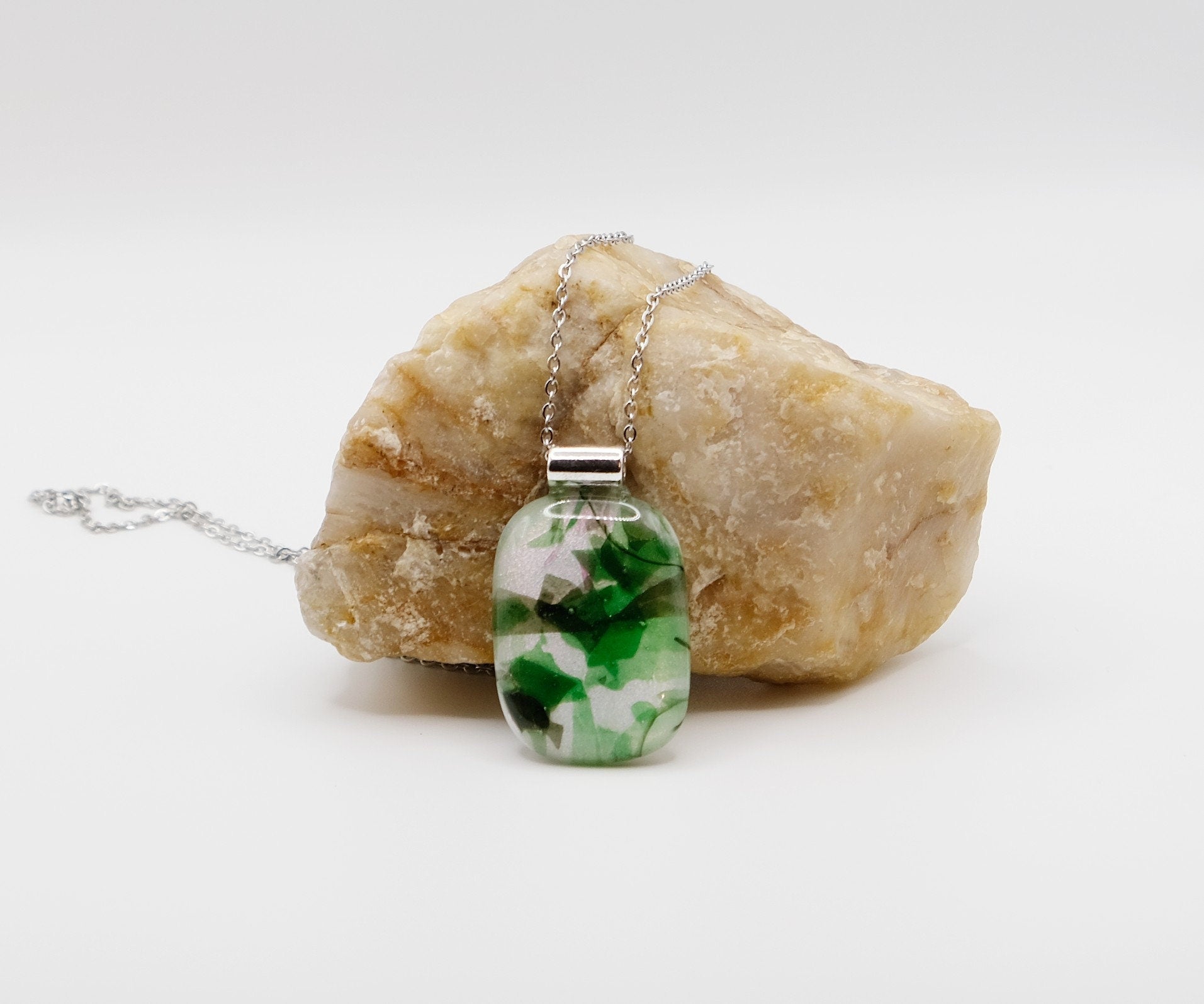 Dichroic green floral on white fused glass statement pendant necklace on 24 inch steel chain. 1.75 x 1 inch pendant seeds glassworks seedsglassworks