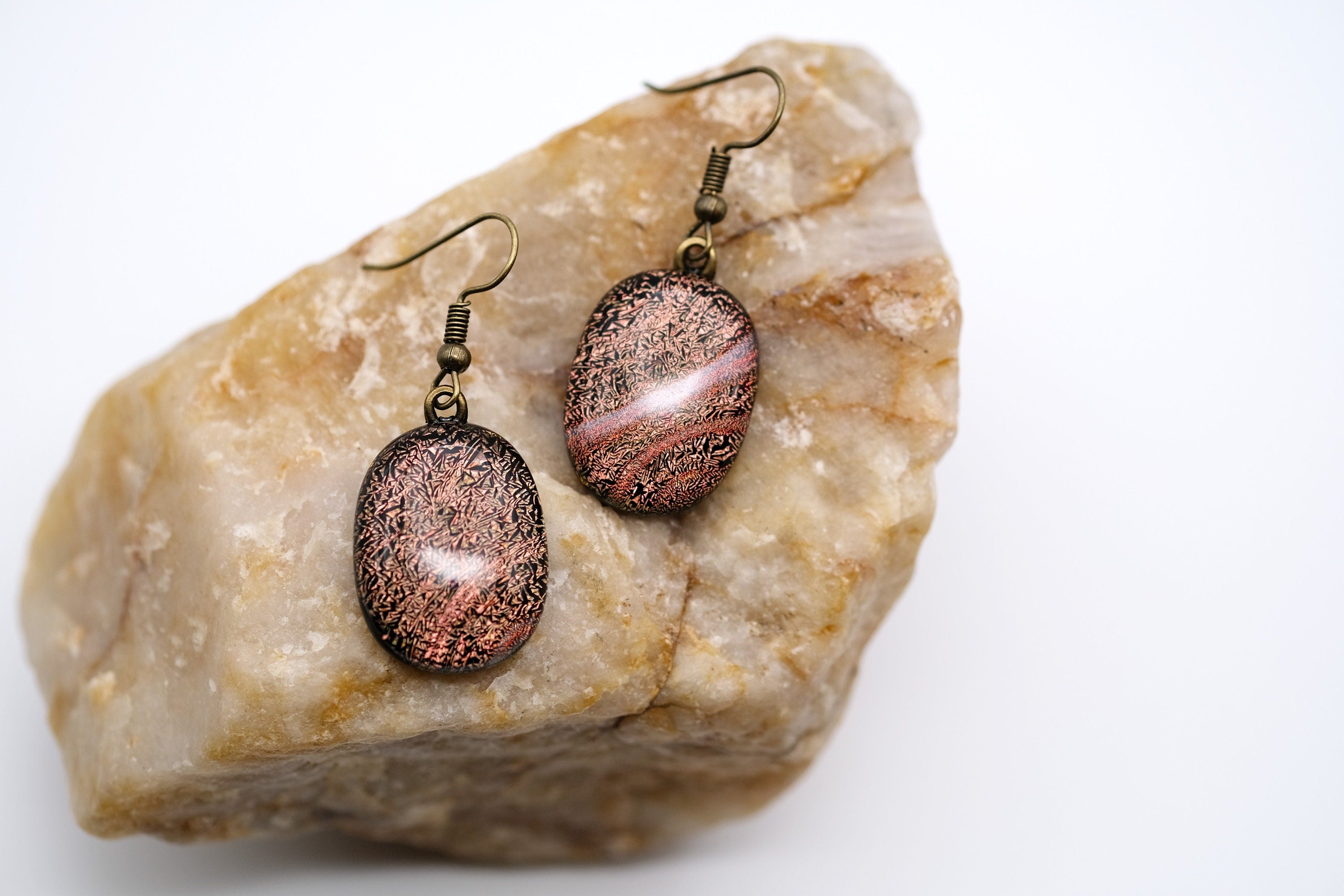 Dichroic orange and black fused glass pierced dangling earrings on antiqued brass tone french wires. Approx 1.5 inches total length seeds glassworks seedsglassworks