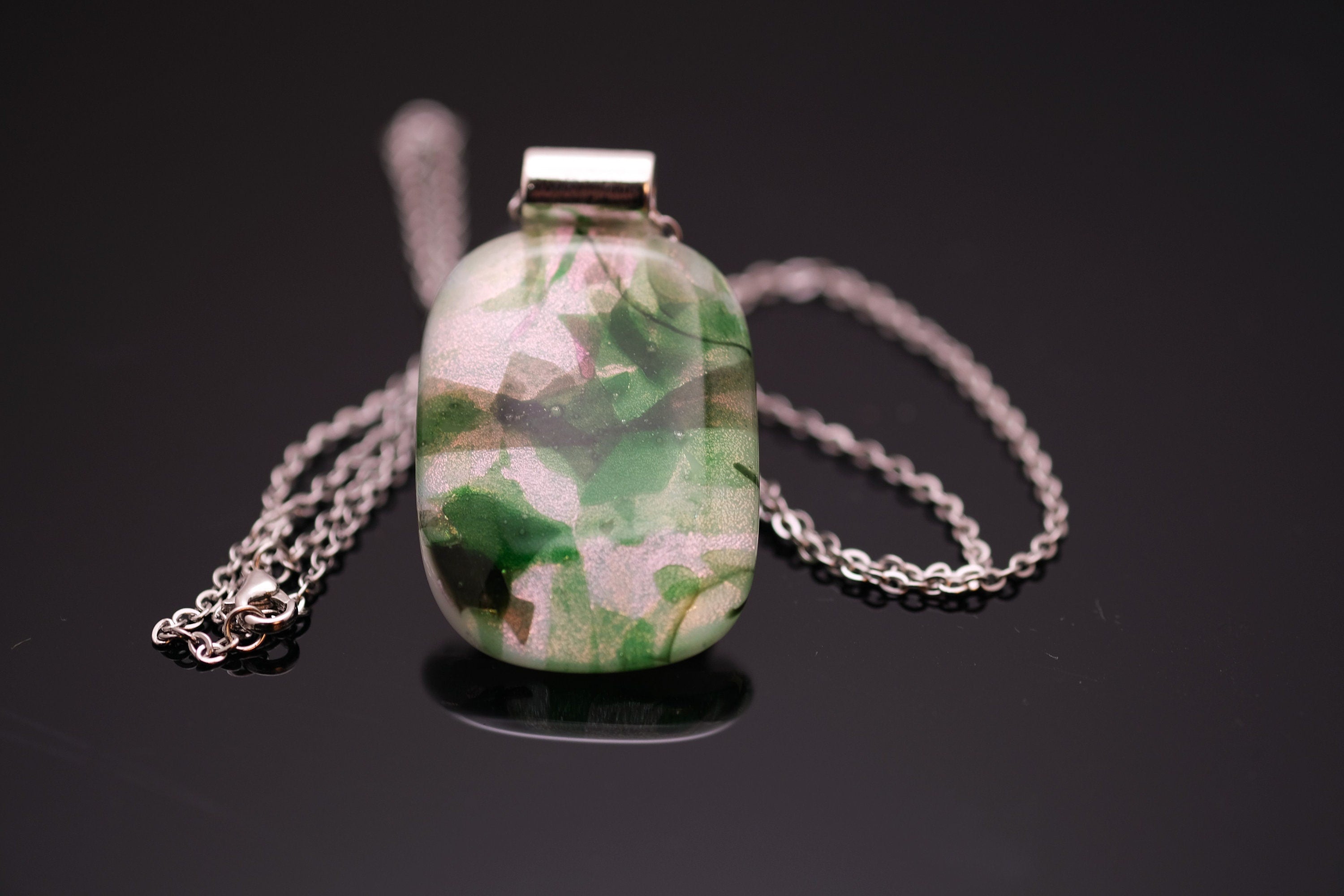 Dichroic green floral on white fused glass statement pendant necklace on 24 inch steel chain. 1.75 x 1 inch pendant seeds glassworks seedsglassworks