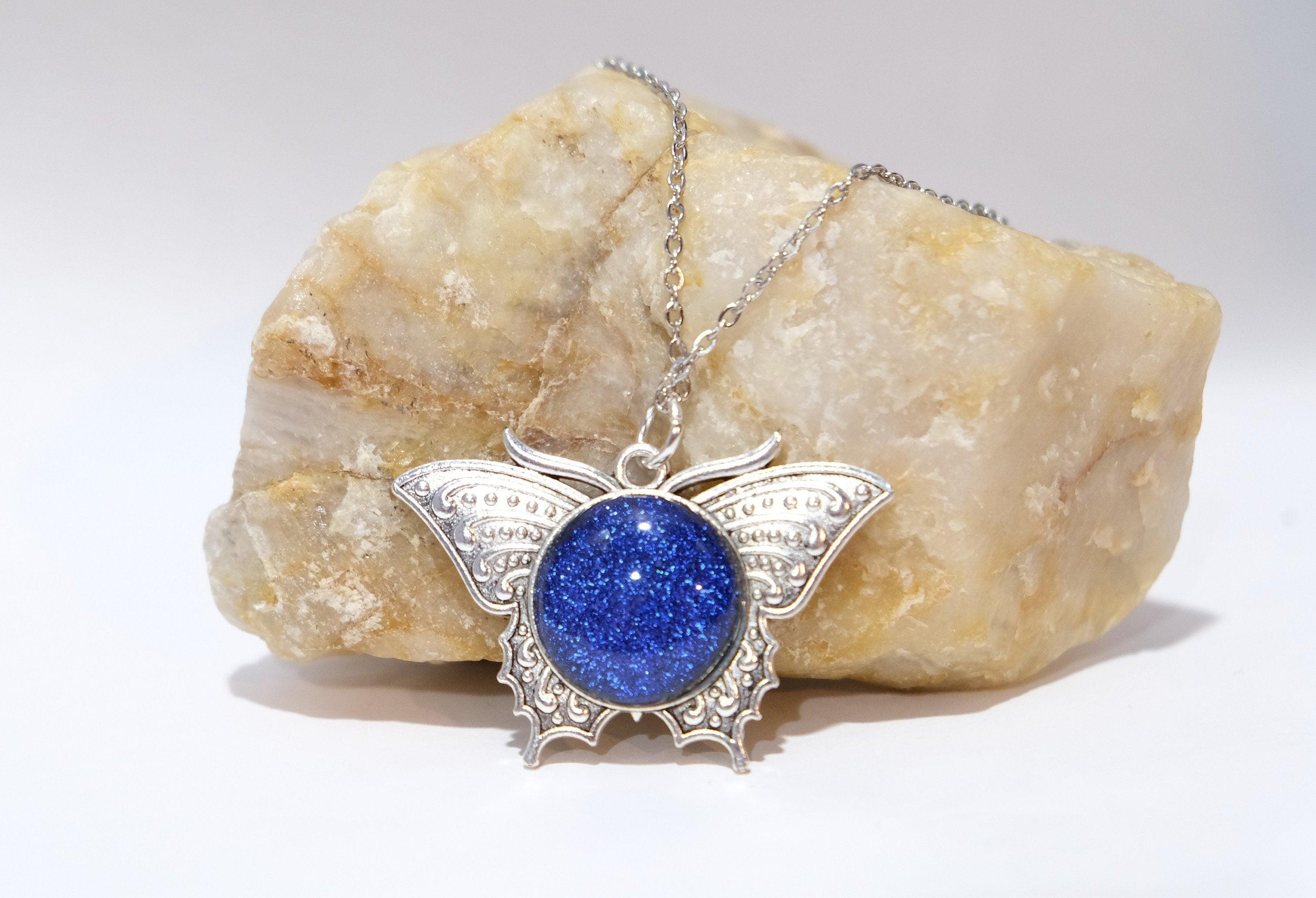 Products Butterfly pendant necklace, silver tone with blue dichroic fused glass center stone on a 20 inch steel chain seeds glassworks seedsglassworks