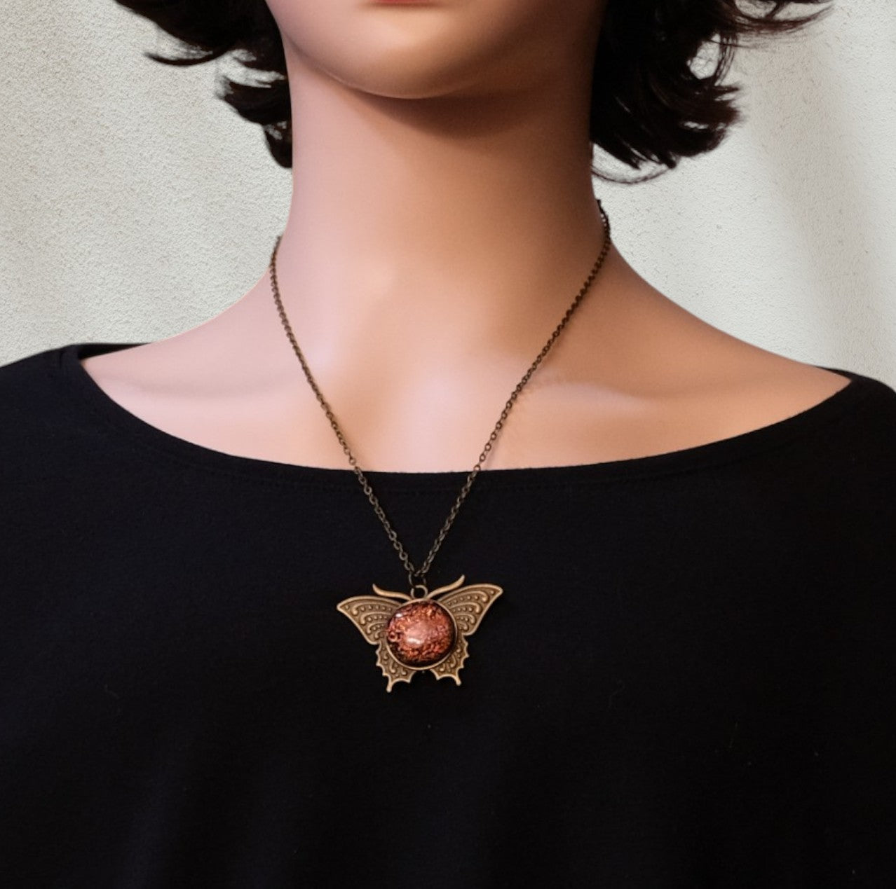 Butterfly pendant necklace, antiqued brass tone with orange dichroic fused glass center stone on a 20 inch antiqued brass chain