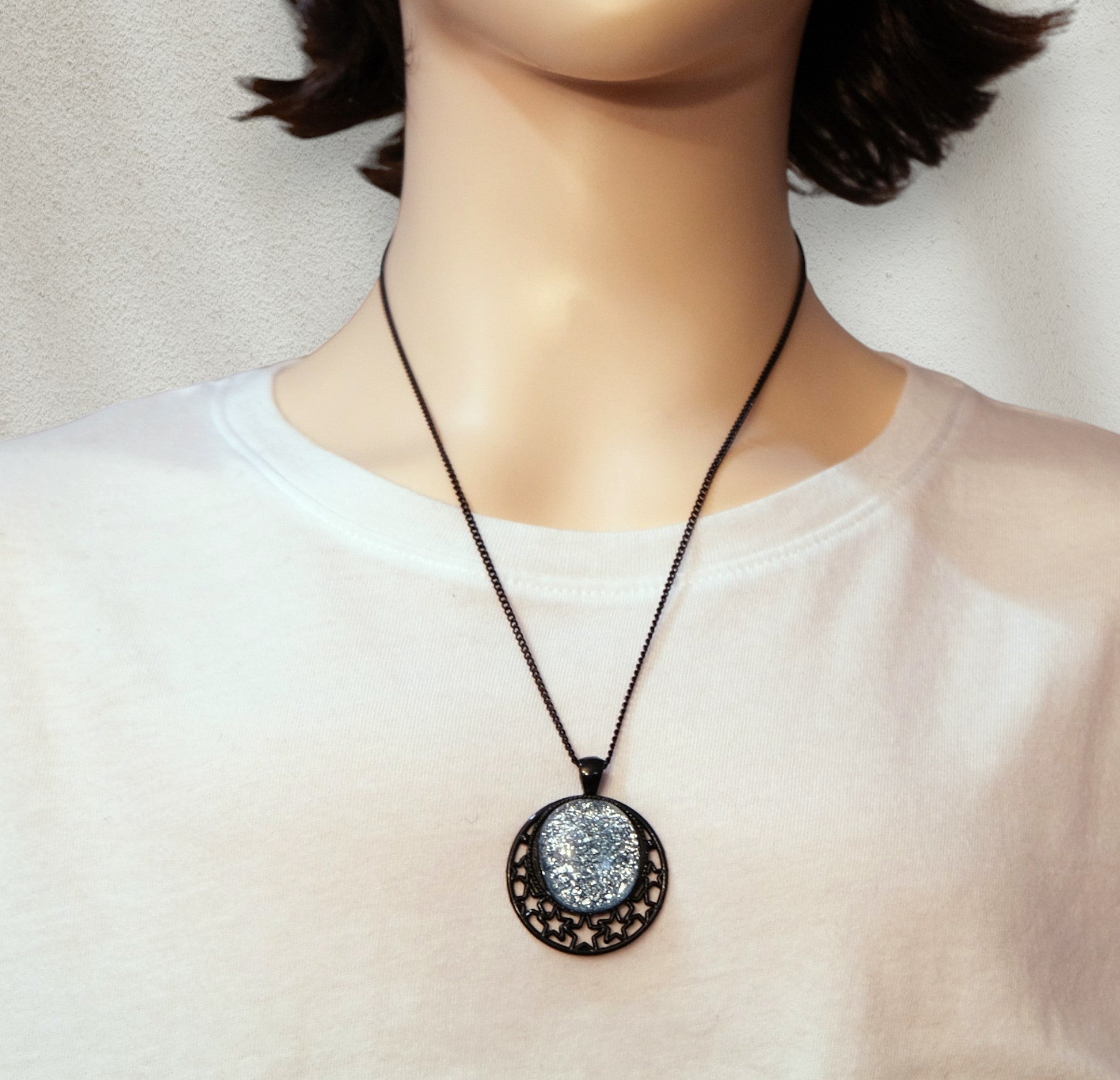 Black Moon and Stars Celestial Pendant Necklace with Silver dichroic glass cabochon on a 20 inch black metal chain.