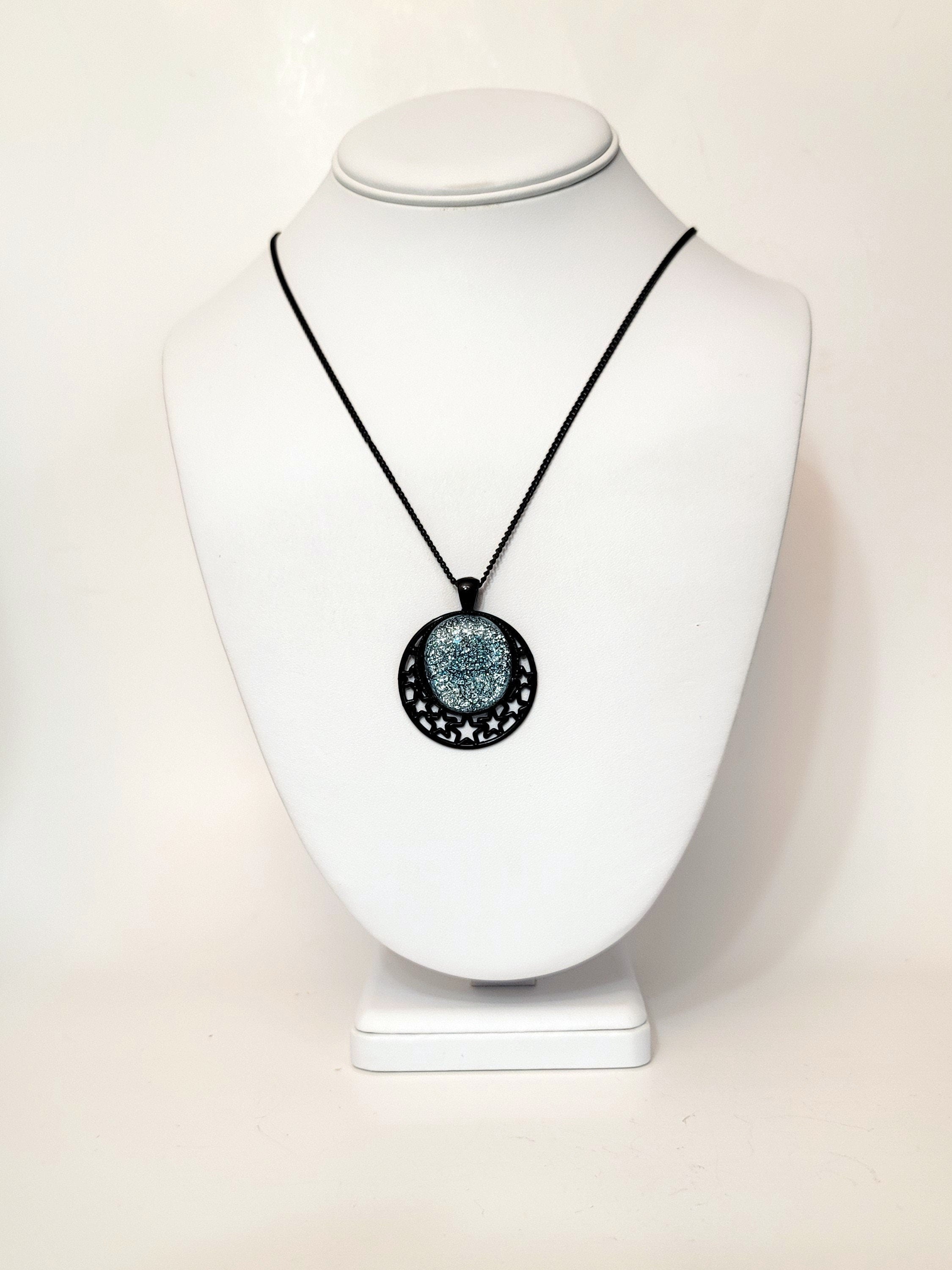 Black Moon and Stars Celestial Pendant Necklace with Silver dichroic glass cabochon on a 20 inch black metal chain.