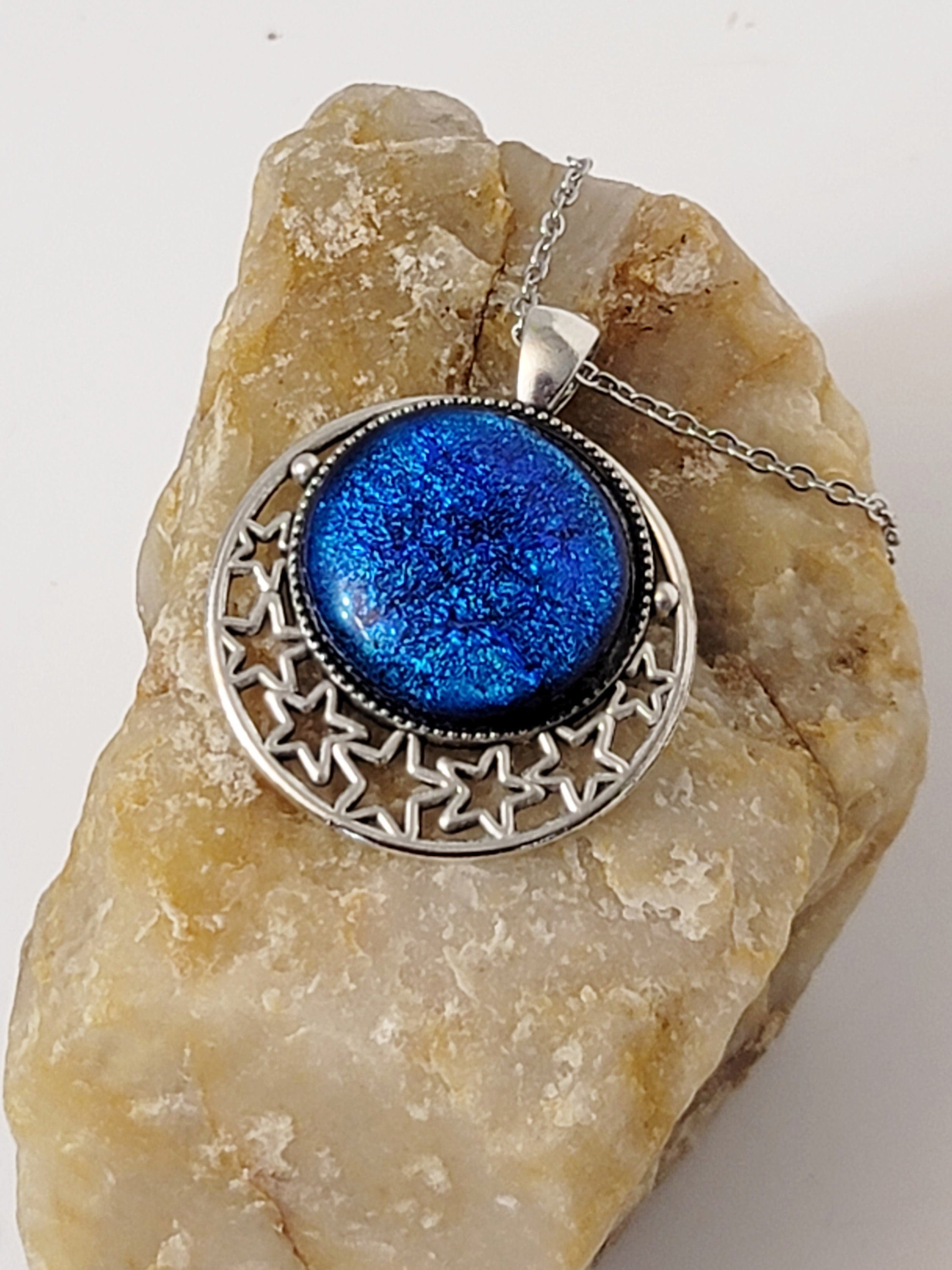 Silver tone Moon and Stars Celestial Pendant Necklace with Royal Blue dichroic glass cabochon on a 20 inch steel metal chain.