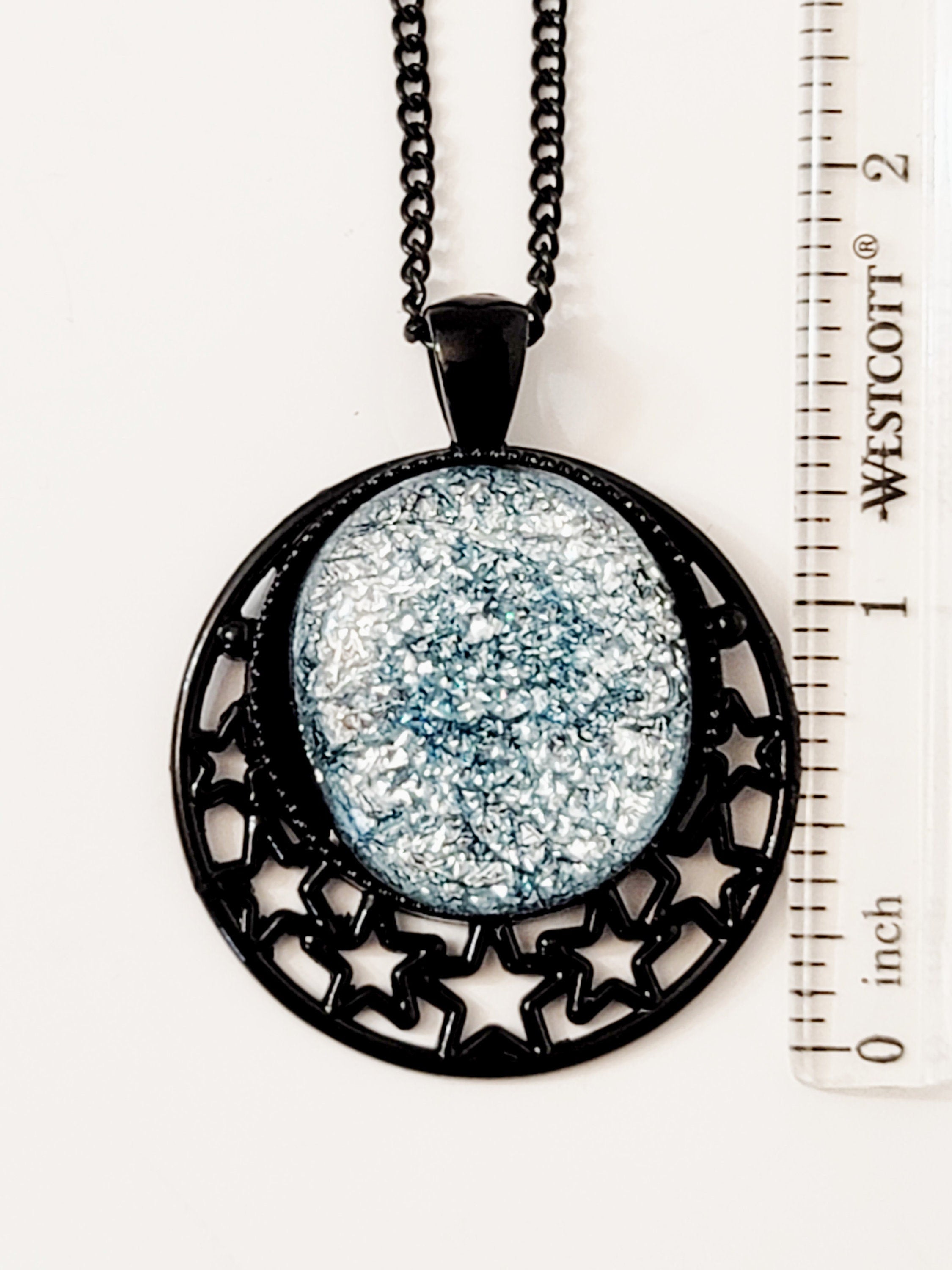 Black Moon and Stars Celestial Pendant Necklace with Silver dichroic glass cabochon on a 20 inch black metal chain.