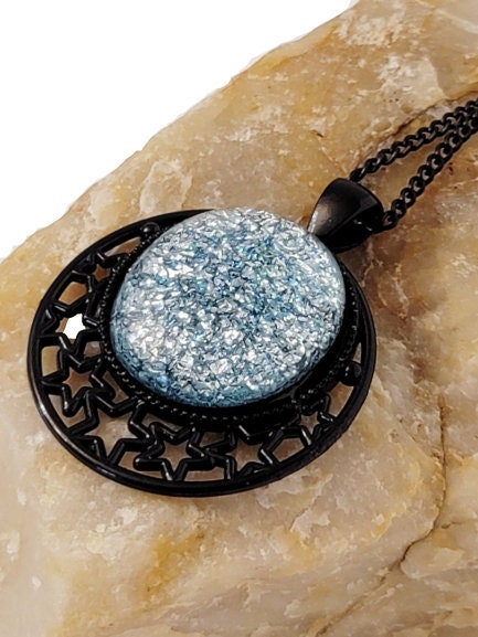 Black Moon and Stars Celestial Pendant Necklace with Silver dichroic glass cabochon on a 20 inch black metal chain.