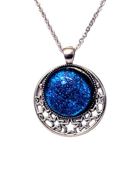 Silver tone Moon and Stars Celestial Pendant Necklace with Royal Blue dichroic glass cabochon on a 20 inch steel metal chain.