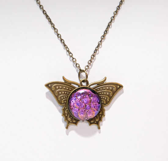 Butterfly pendant necklace, brass tone with pink purple dichroic fused glass center stone on a 20 inch brass tone chain seeds glassworks seedsglassworks