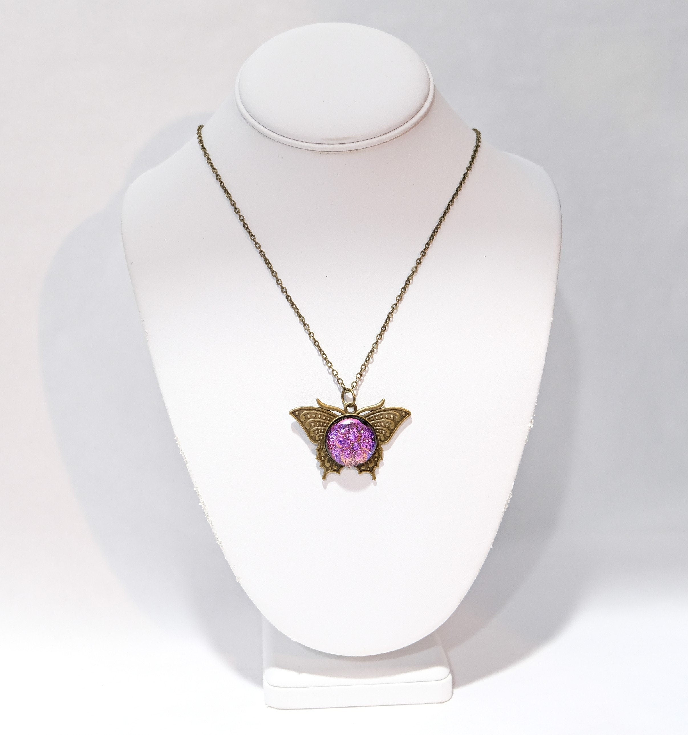 Butterfly pendant necklace, brass tone with pink purple dichroic fused glass center stone on a 20 inch brass tone chain seeds glassworks seedsglassworks