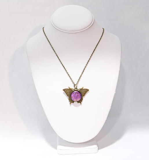 Butterfly pendant necklace, brass tone with pink purple dichroic fused glass center stone on a 20 inch brass tone chain seeds glassworks seedsglassworks