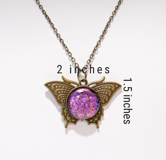 Butterfly pendant necklace, brass tone with pink purple dichroic fused glass center stone on a 20 inch brass tone chain seeds glassworks seedsglassworks