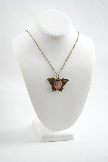 Butterfly pendant necklace, antiqued brass tone with orange dichroic fused glass center stone on a 20 inch antiqued brass chain seeds glassworks seedsglassworks