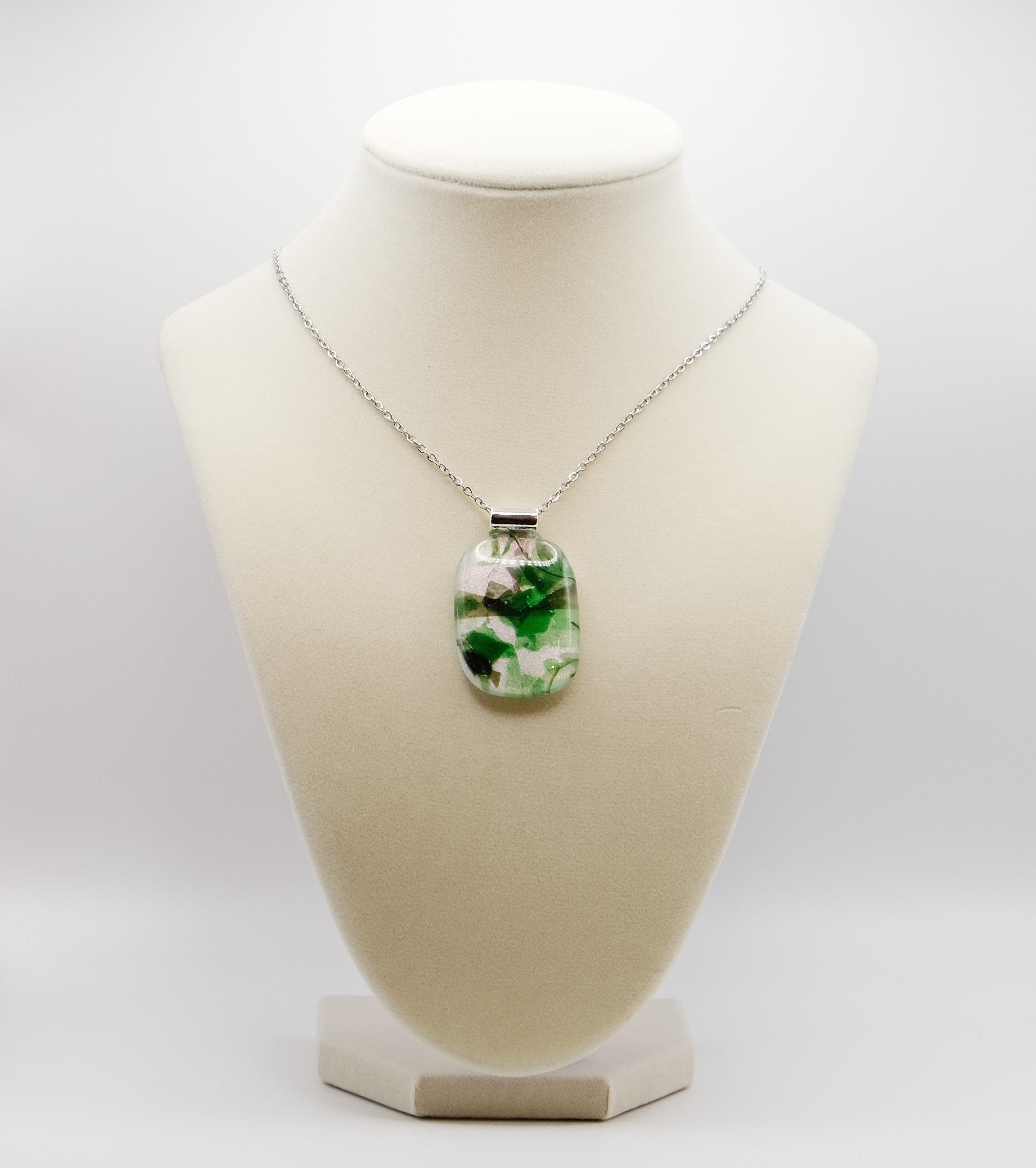 Dichroic green floral on white fused glass statement pendant necklace on 24 inch steel chain. 1.75 x 1 inch pendant seeds glassworks seedsglassworks