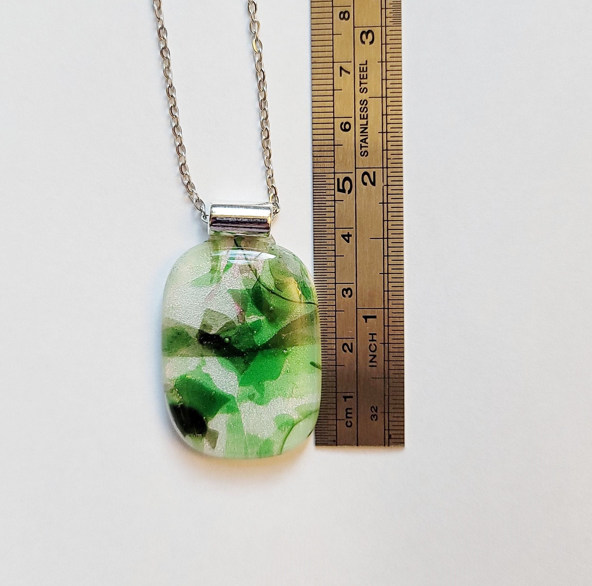 Dichroic green floral on white fused glass statement pendant necklace on 24 inch steel chain. 1.75 x 1 inch pendant seeds glassworks seedsglassworks