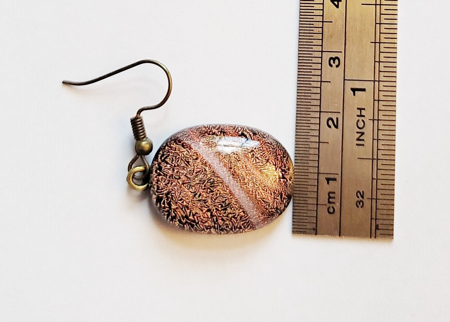 Dichroic orange and black fused glass pierced dangling earrings on antiqued brass tone french wires. Approx 1.5 inches total length seeds glassworks seedsglassworks