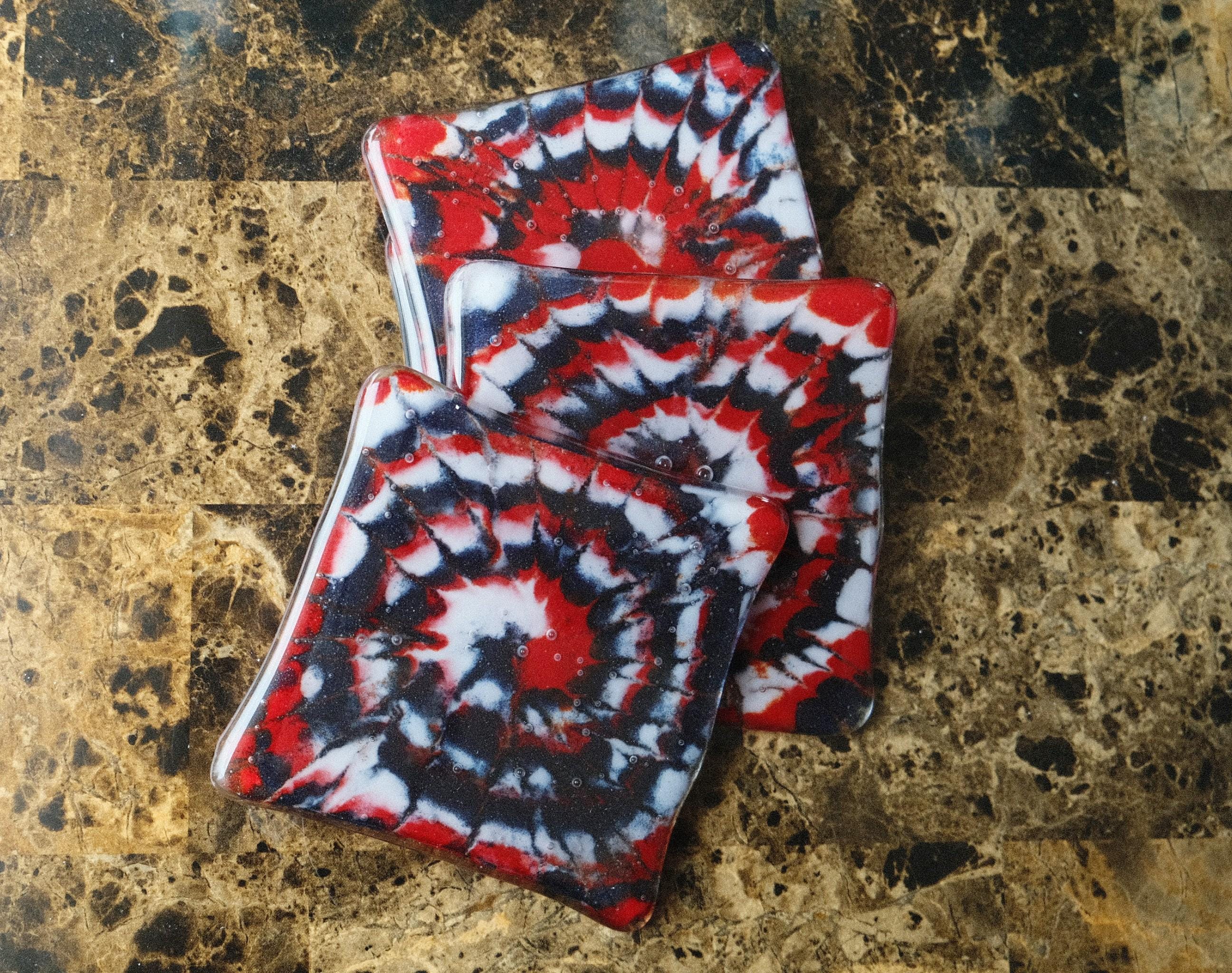 Set of 4 fused glass drink coasters with a red, blue, and white tie-dye design, featuring a patriotic and nautical vibe.