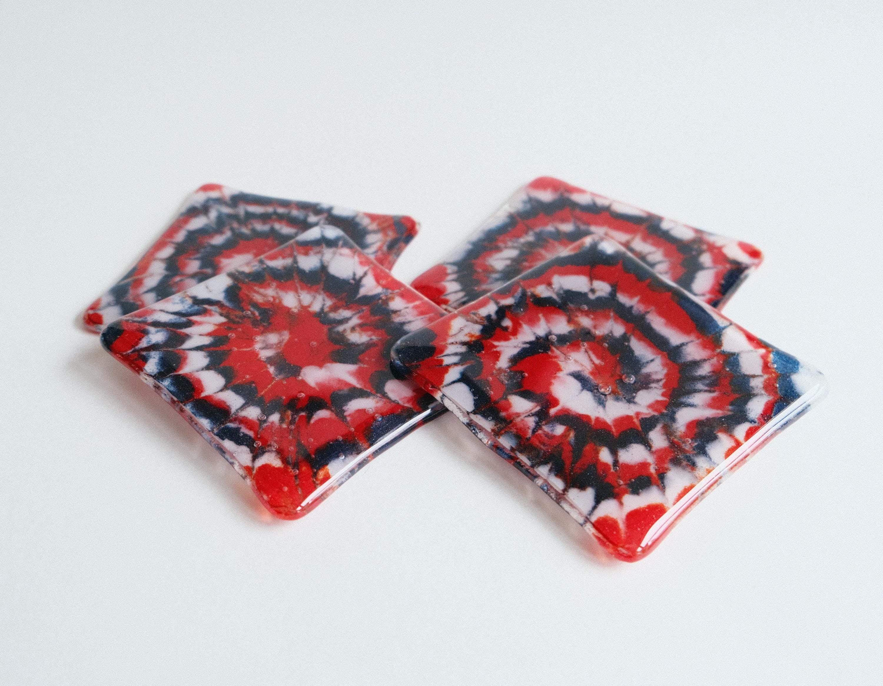 Set of 4 fused glass drink coasters with a red, blue, and white tie-dye design, featuring a patriotic and nautical vibe.