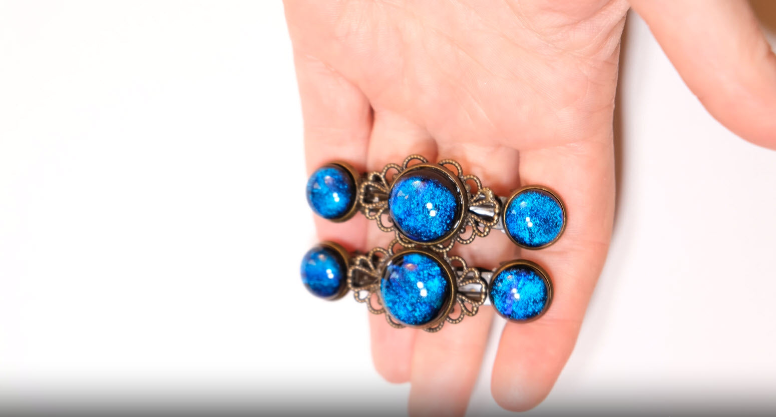 Barrette pair, bronze flowers with blue dichroic fused glass cabochons, french clip, 2 1/4 inches seeds glassworks seedsglassworks