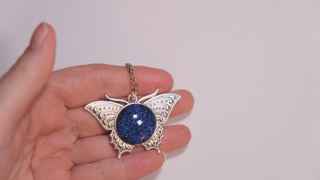 Products Butterfly pendant necklace, silver tone with blue dichroic fused glass  center stone on a 20 inch steel chain seeds glassworks seedsglassworks