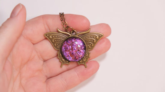 Butterfly pendant necklace, brass tone with pink purple dichroic fused glass center stone on a 20 inch brass tone chain seeds glassworks seedsglassworks