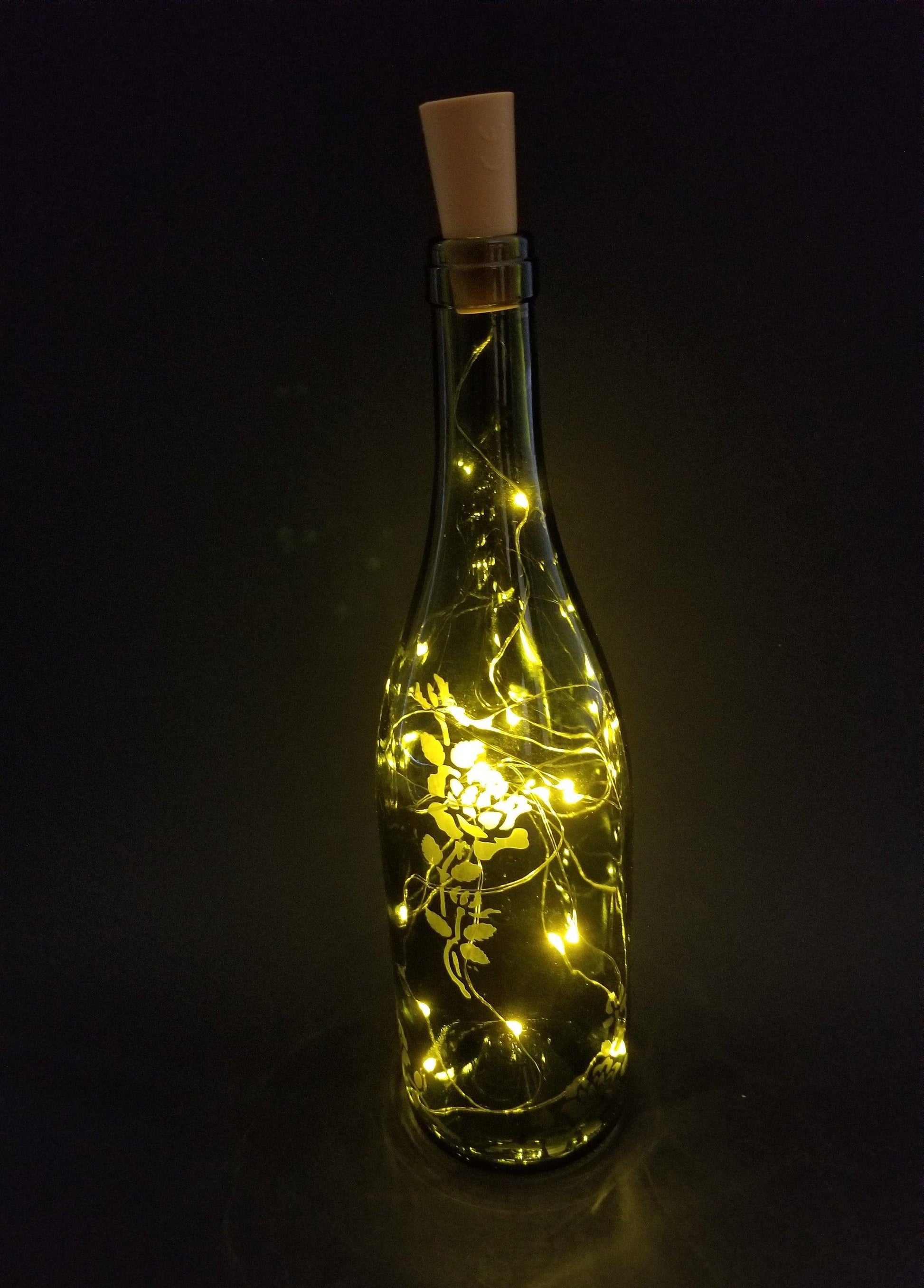 Recycled Wine Bottle with Fairy Lights and Rose Etching from seeds glassworks