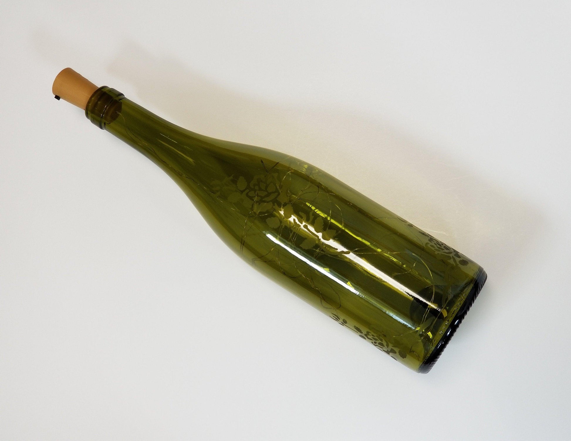Recycled Wine Bottle with Fairy Lights and Rose Etching from seeds glassworks