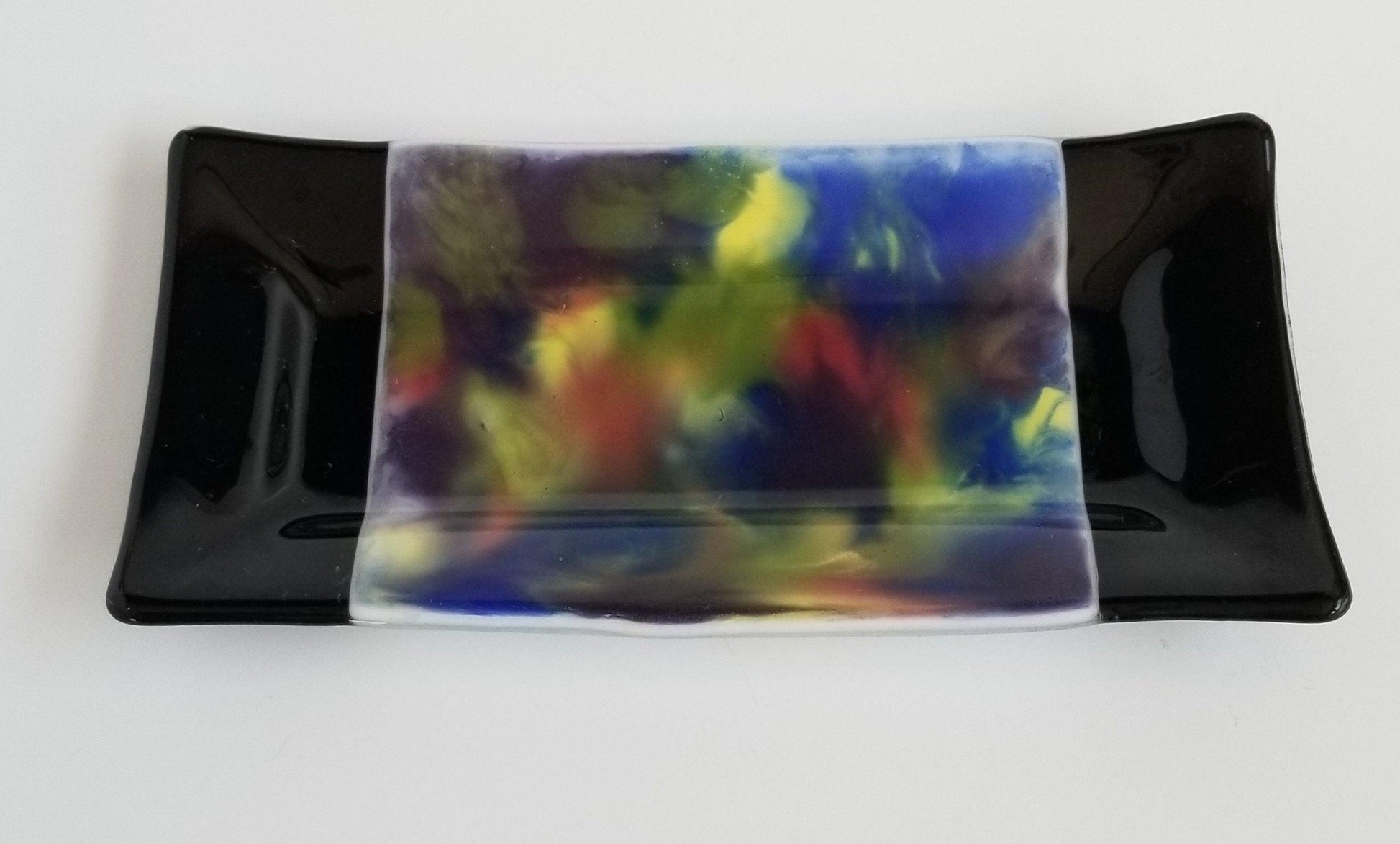 fused glass 10 inch serving plate with colorful rainbow swirls and black accents, from Seeds Glassworks
