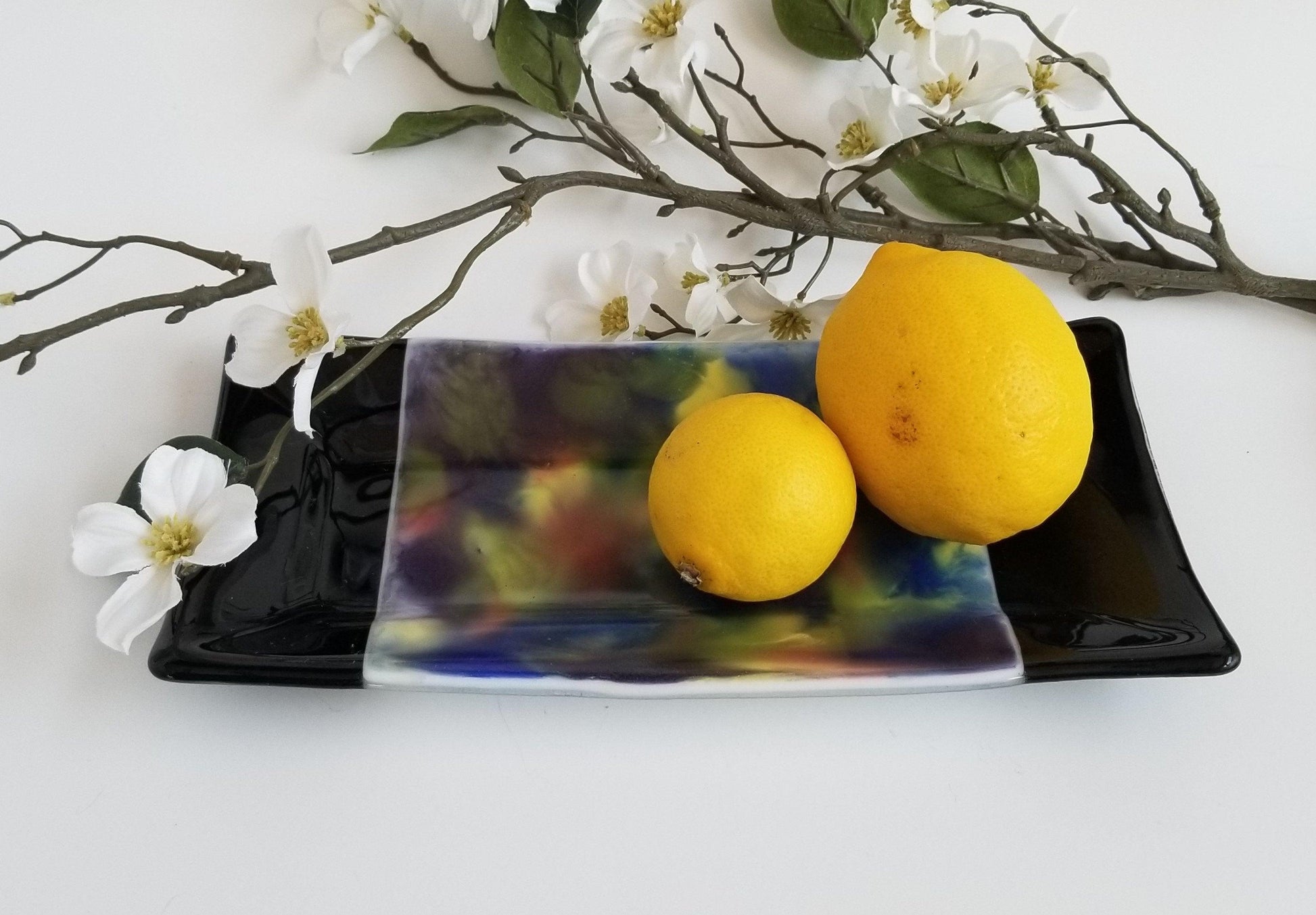 fused glass 10 inch serving plate with colorful rainbow swirls and black accents, from Seeds Glassworks