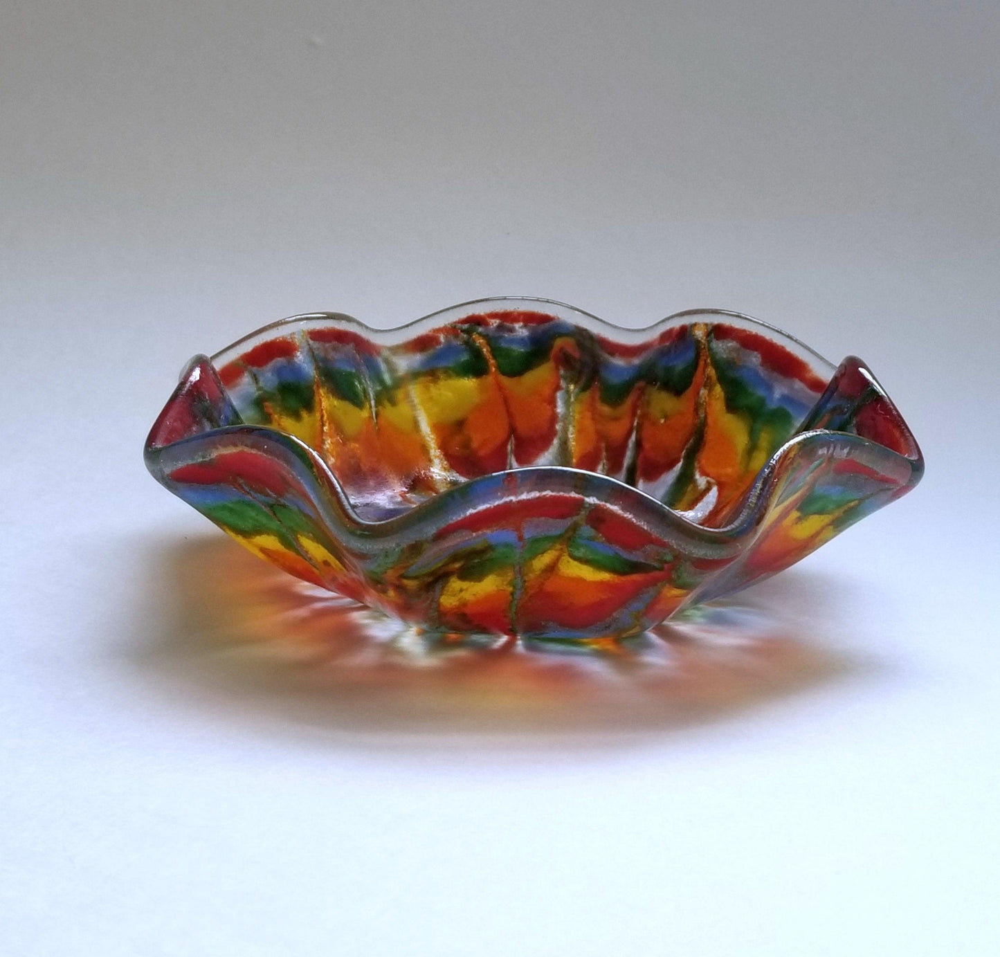 Tie Dyed ruffle edge 5 inch fused glass bowl. Seeds Glassworks