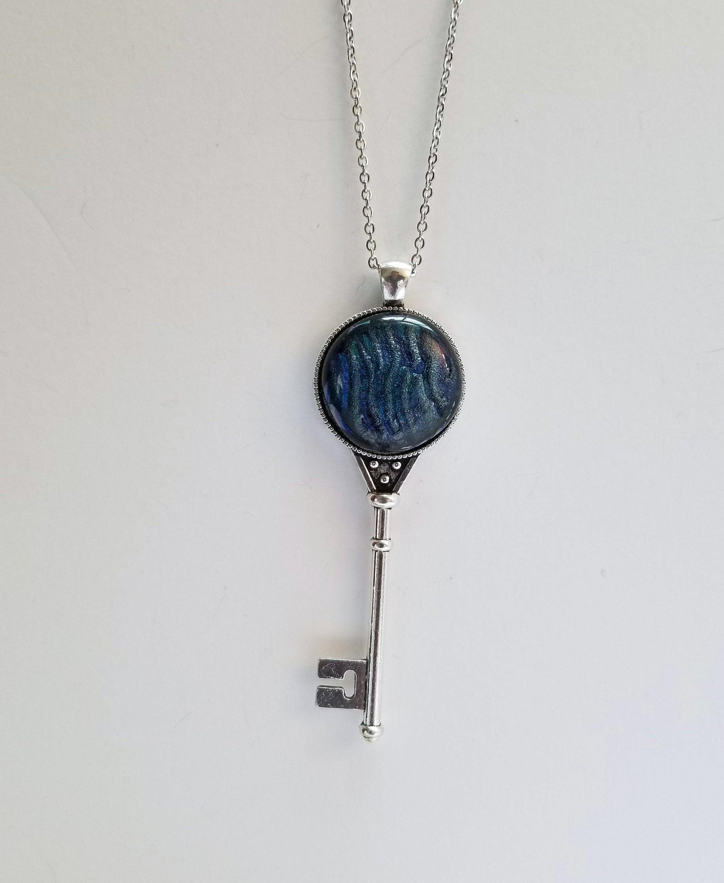 Silver Finish Skeleton Key with Fused Glass Blue Wave Dichroic cabochon on 24 inch Steel chain Seeds Glassworks