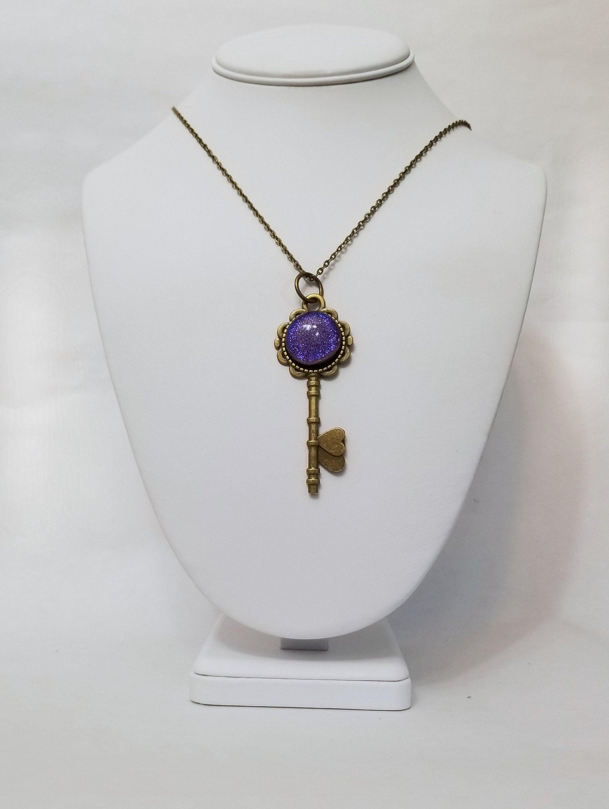 Antiqued Brass  Flowered Skeleton Key with Fused Glass Purple Dichroic cabochon on 24 inch brass plated chain