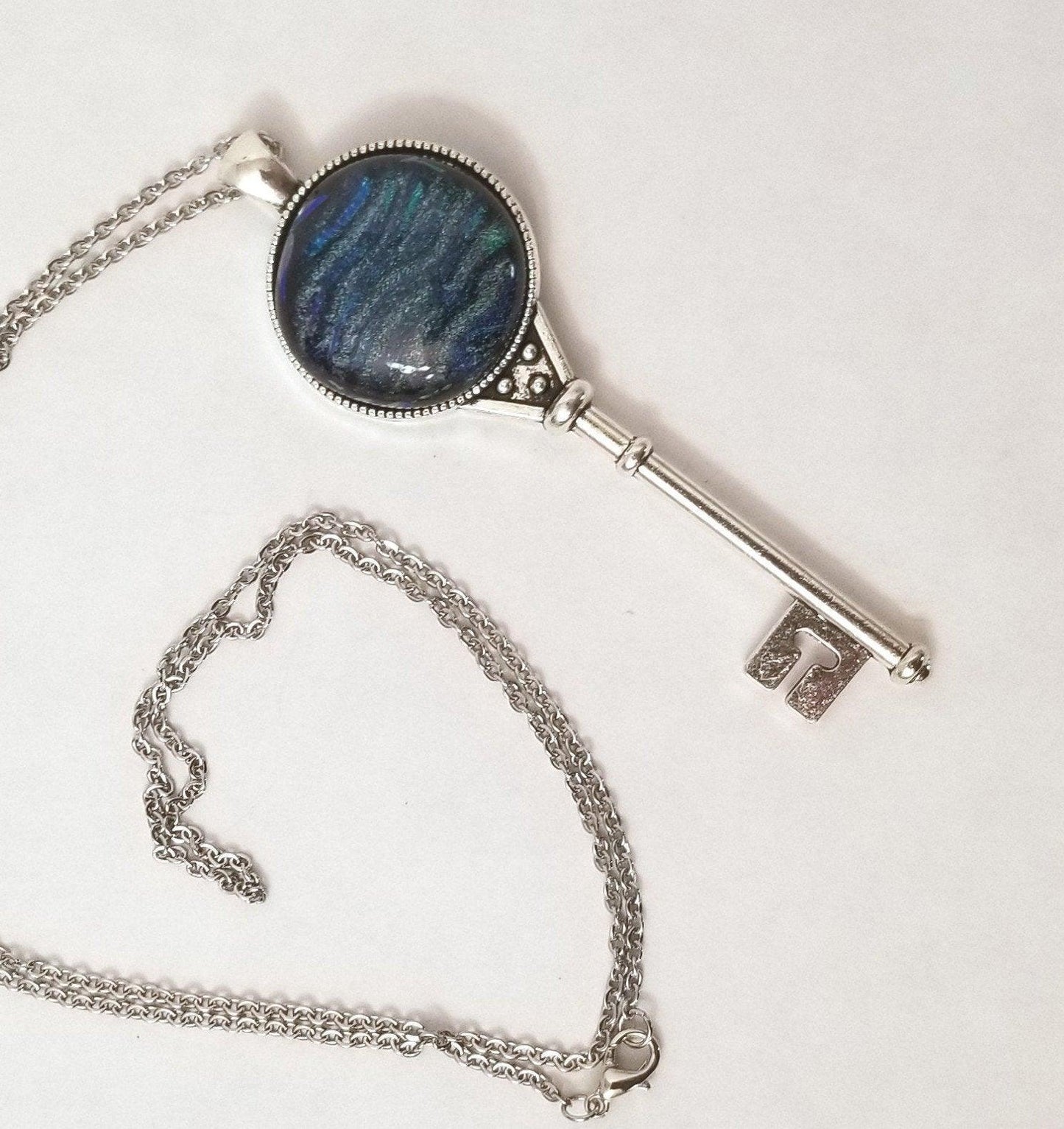 Silver Finish Skeleton Key with Fused Glass Blue Wave Dichroic cabochon on 24 inch Steel chain Seeds Glassworks