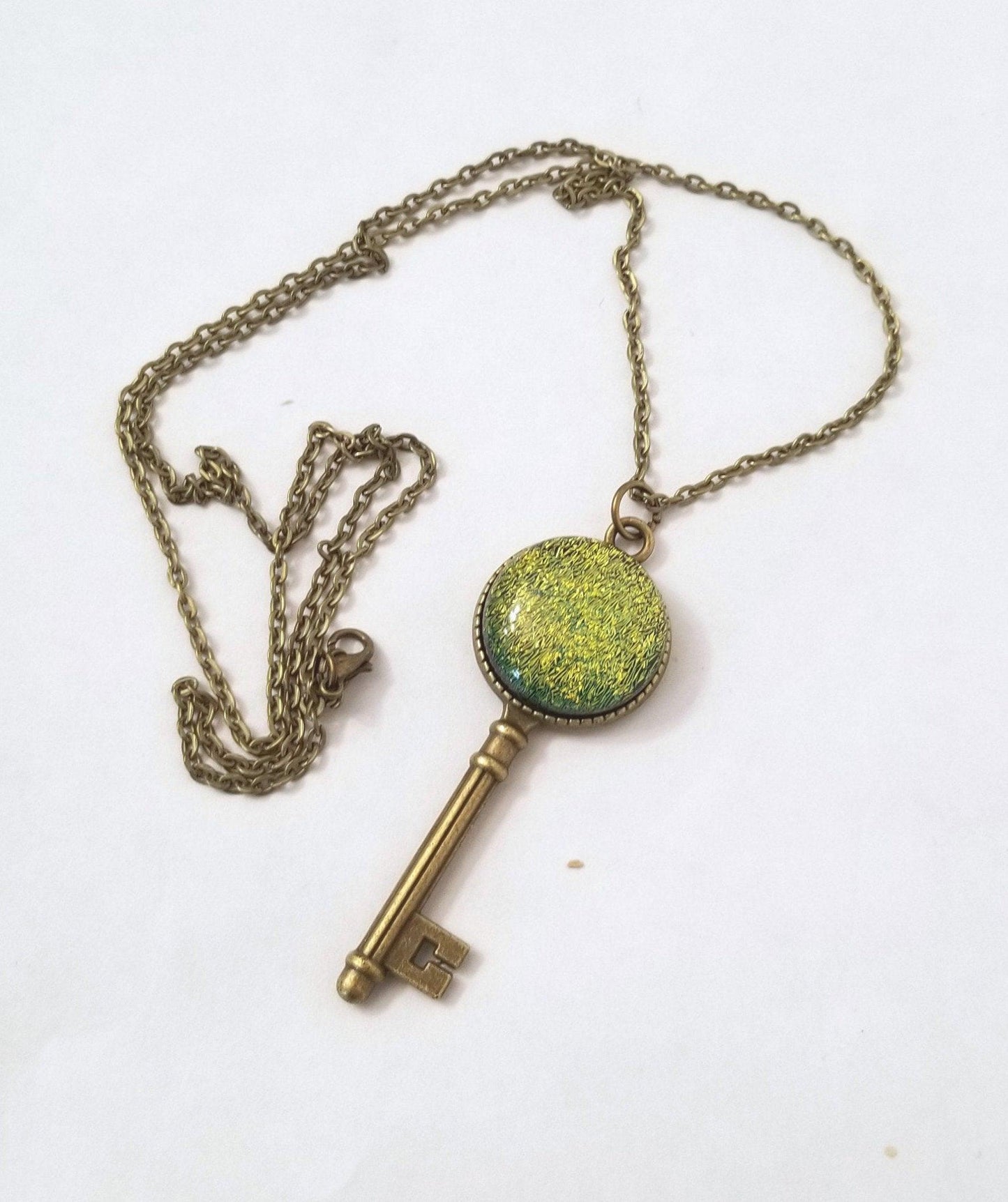 Antiqued Brass Small  Skeleton Key with Fused Glass Green Dichroic cabochon on 24 inch brass plated chain