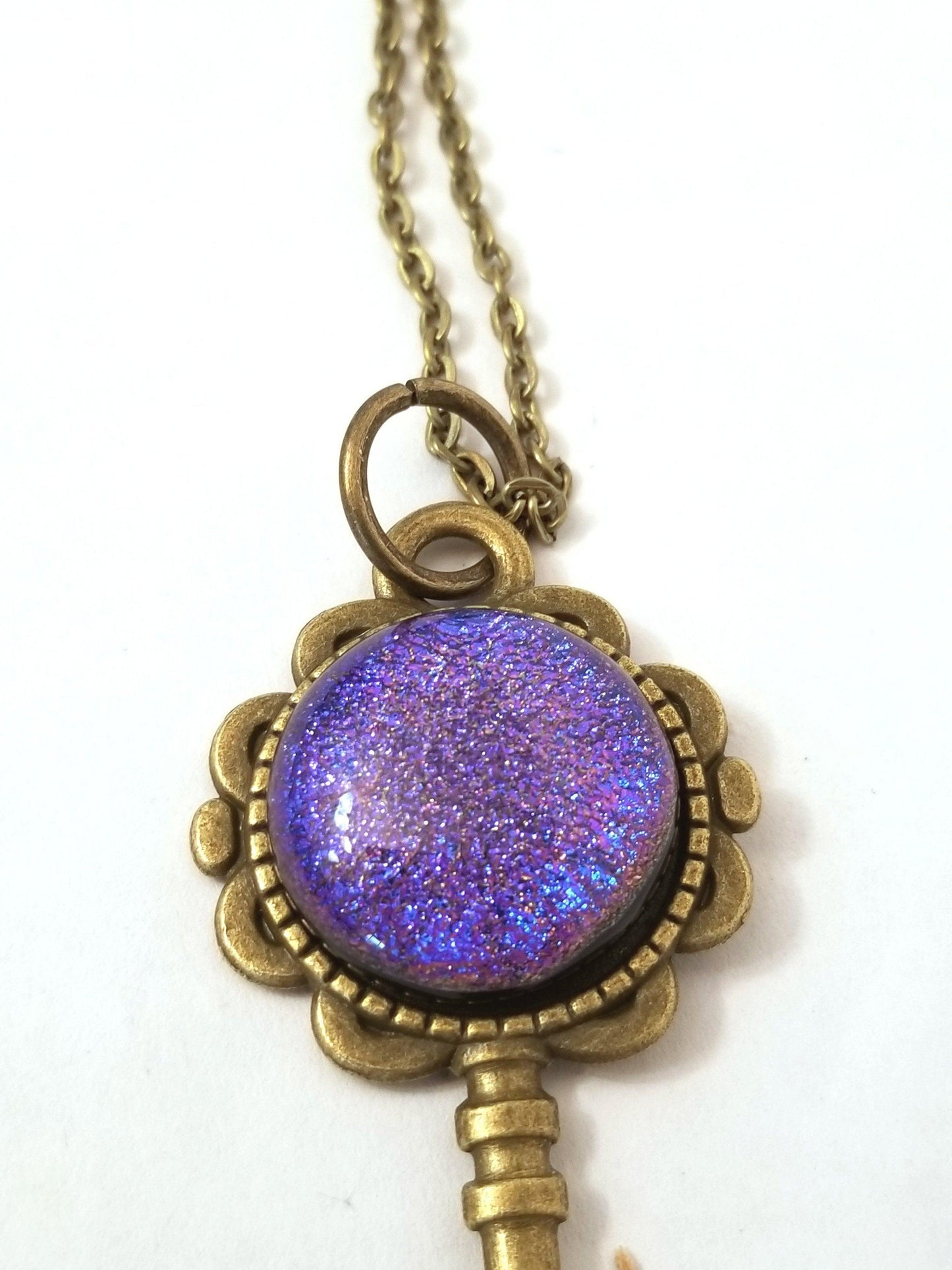 Antiqued Brass  Flowered Skeleton Key with Fused Glass Purple Dichroic cabochon on 24 inch brass plated chain
