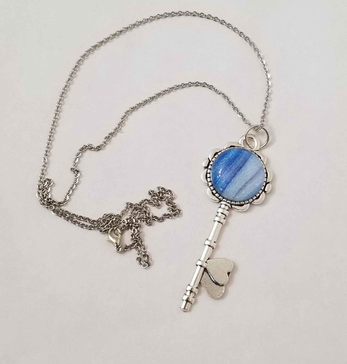 Silver finish Flowered Skeleton Key with Fused Glass Blue Stripe Dichroic cabochon on 24 inch stainless steel chain Seeds Glassworks seedsglassworks jewelry
