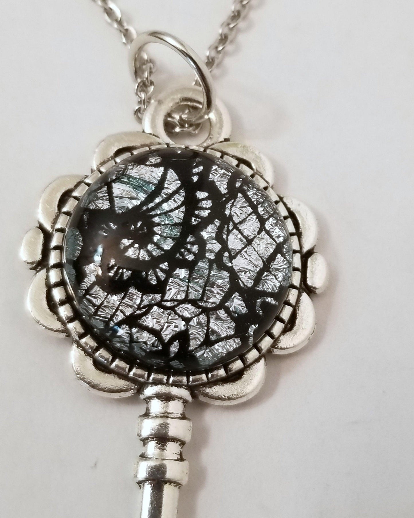 Silver finish Flowered Skeleton Key with Fused Glass Silver Lace Dichroic cabochon on 24 inch stainless steel chain Seeds Glassworks