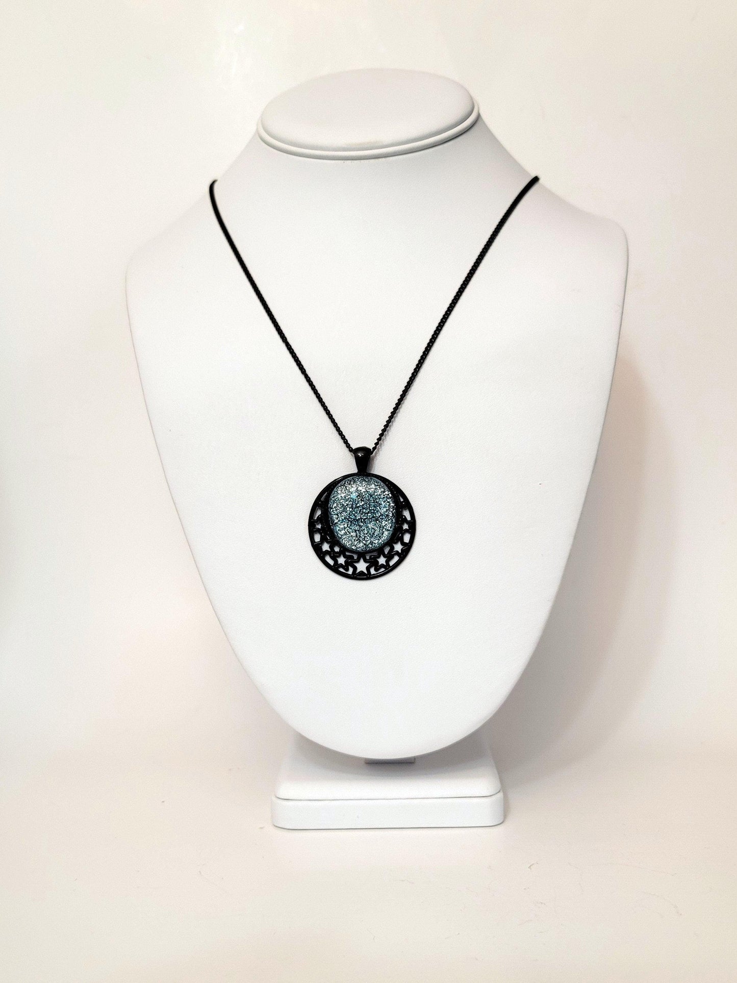 Black Stars Pendant with Silver dichroic glass cabochon on a 20 inch black metal chain. seeds glassworks fused glass jewelry seedsglassworks