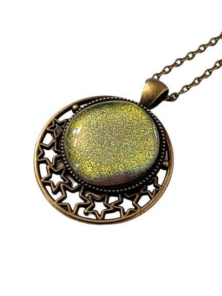 Antiqued brass Stars Pendant with Green dichroic glass cabochon on a 20 inch brass chain seeds glassworks. fused glass seedsglassworks