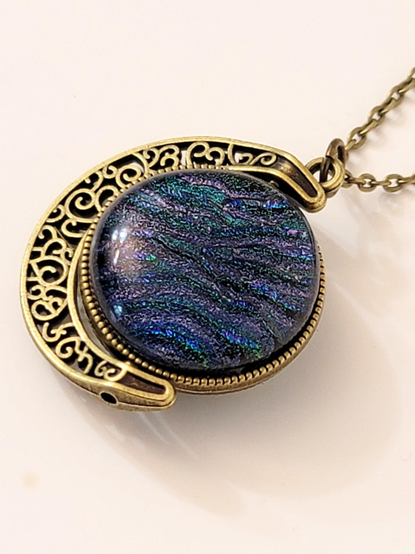 Blue and Green Dichroic Glass double sided Crescent Moon Pendant with Spinner antique bronze look on 20 inch chain. seeds glassworks, fused glass seedsglassworks