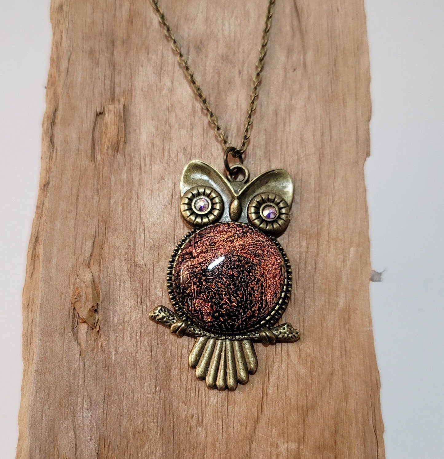 Bronze tone owl with orange dichroic fused glass pendant on an 20 inch bronze chain