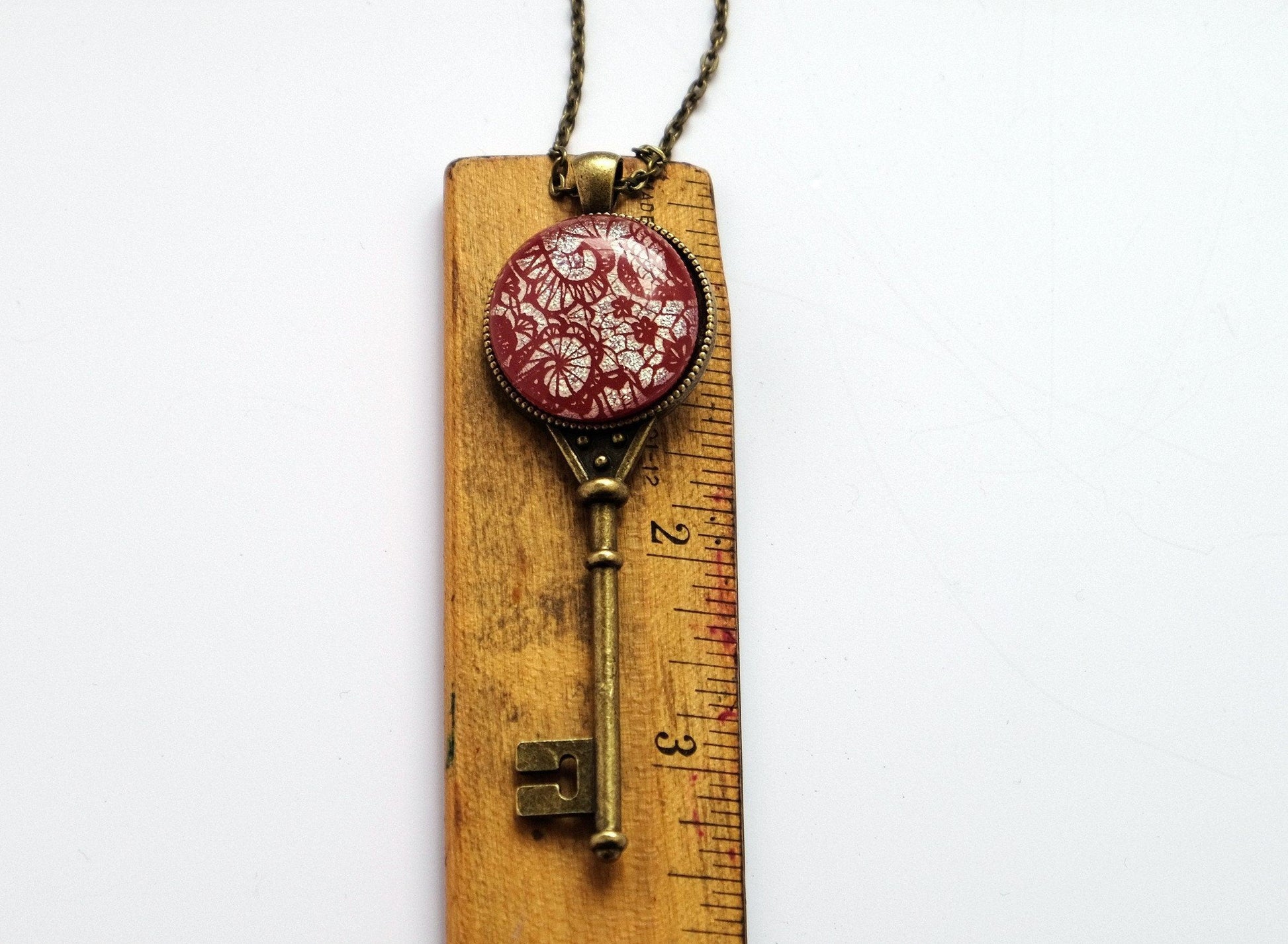 Antiqued Brass Skeleton Key pendant necklace with Fused Glass red lace Dichroic cabochon on 24 inch brass plated chain jewelry  steam punk and Victorian style seeds glassworks seedsglassworks