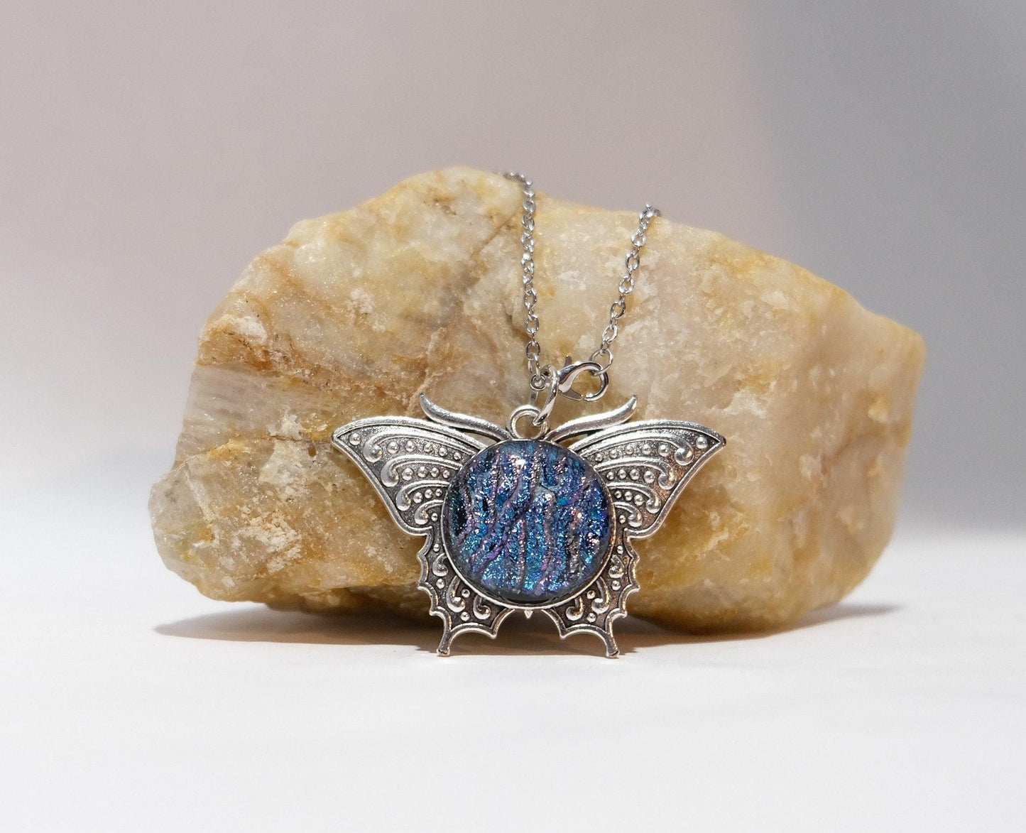 Butterfly pendant necklace, silver tone with blue/multicolor dichroic fused glass center stone on a 20 inch steel chain
