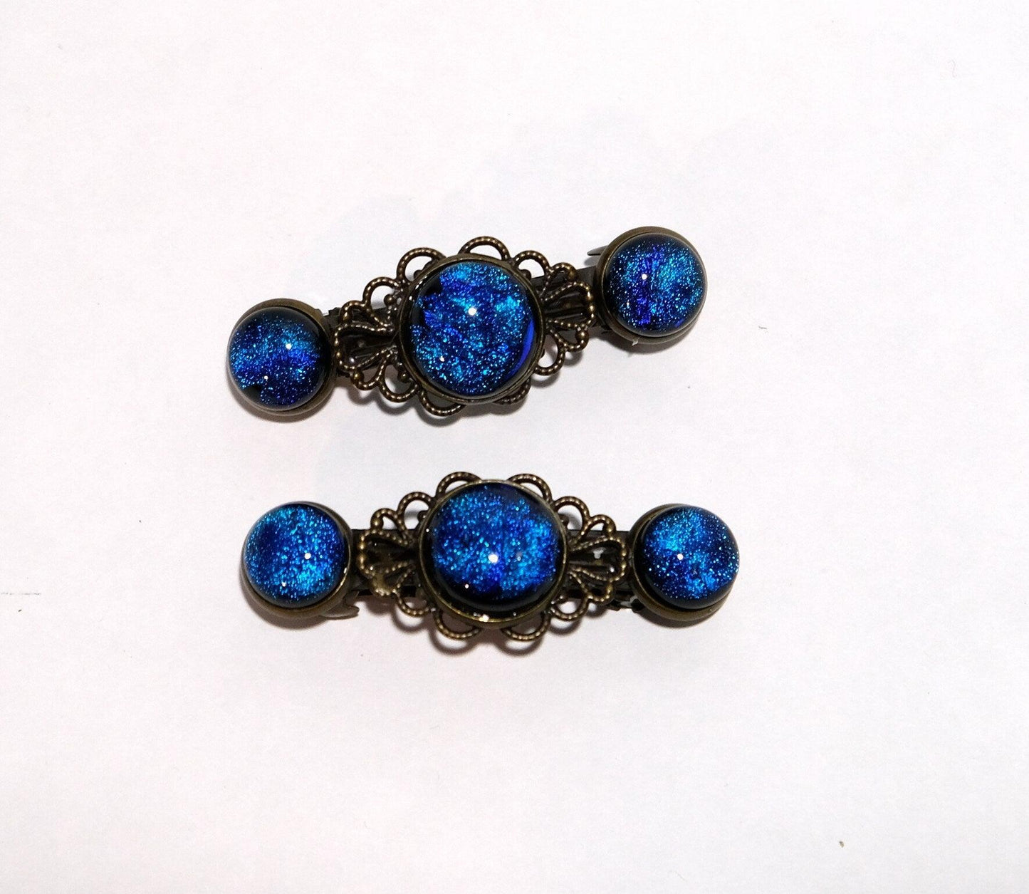 Barrette pair, bronze flowers with blue dichroic fused glass cabochons, french clip, 2 1/4 inches