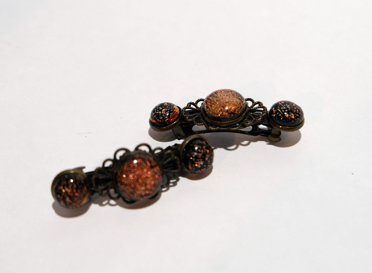 Barrette pair, bronze flowers with orange dichroic fused glass cabochons, french clip, 2 1/4 inches seeds glassworks seedsglassworks