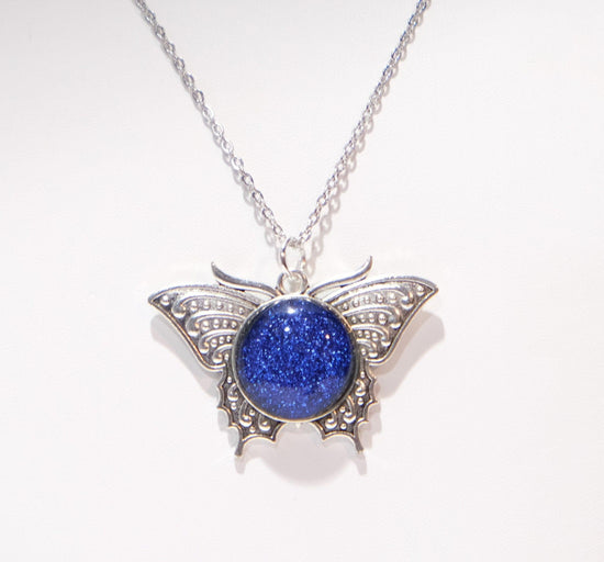 Products Butterfly pendant necklace, silver tone with blue dichroic fused glass  center stone on a 20 inch steel chain seeds glassworks seedsglassworks