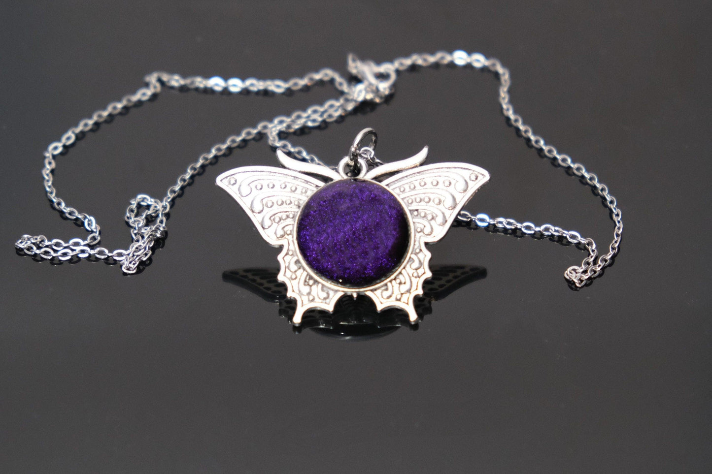 Butterfly pendant necklace, silver tone with dark purple dichroic fused glass center stone on a 20 inch steel chain seeds glassworks seedsglassworks
