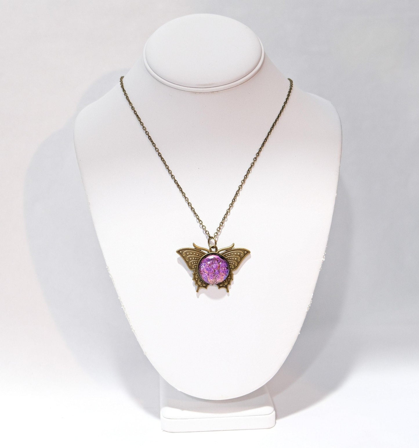Butterfly pendant necklace, brass tone with dark purple dichroic fused glass center stone on a 20 inch brass tone chain seeds glassworks seedsglassworks