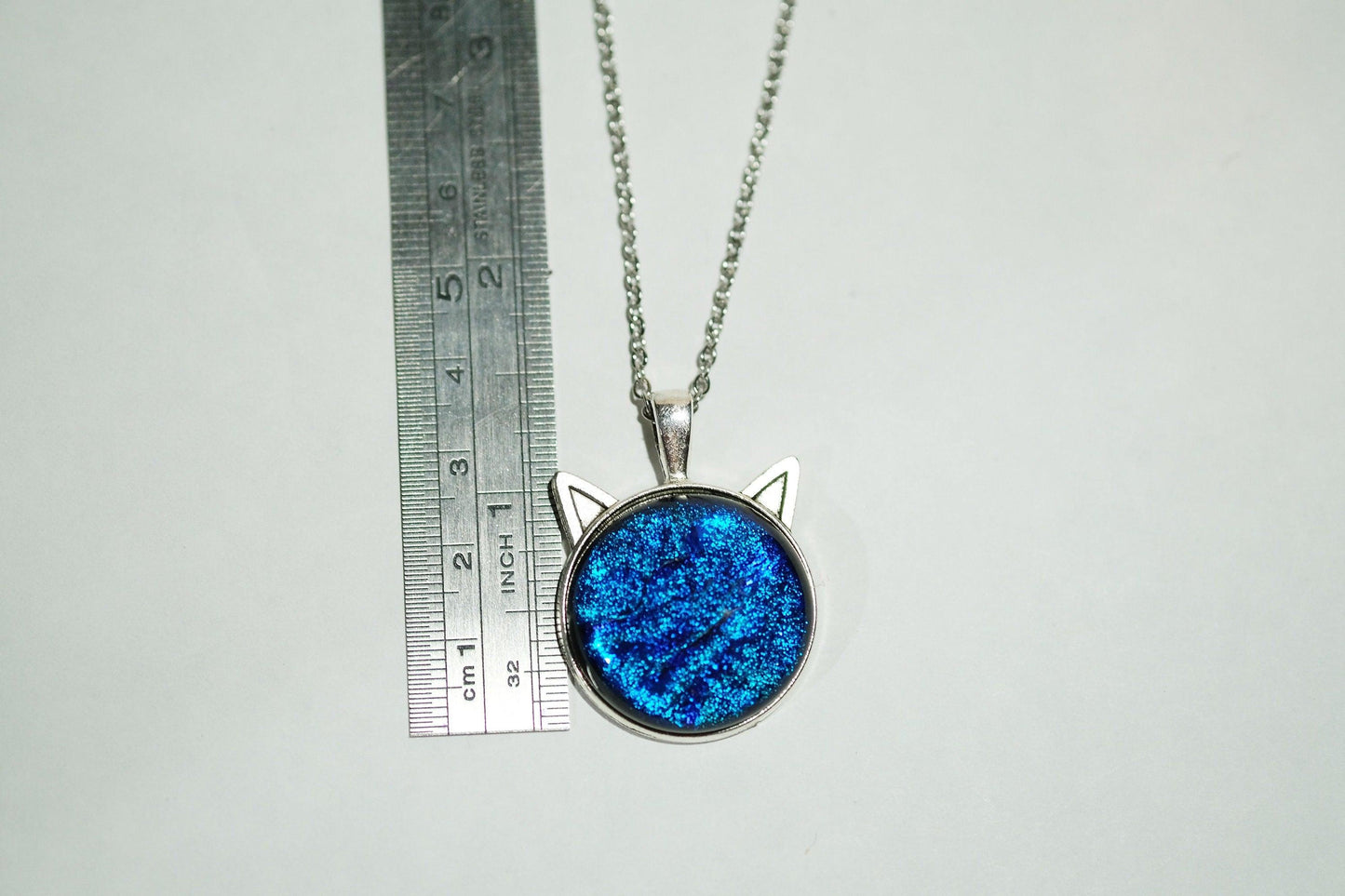 Silver Cat pendant necklace, with blue sparkling dichroic fused glass center stone on a 20 inch steel chain