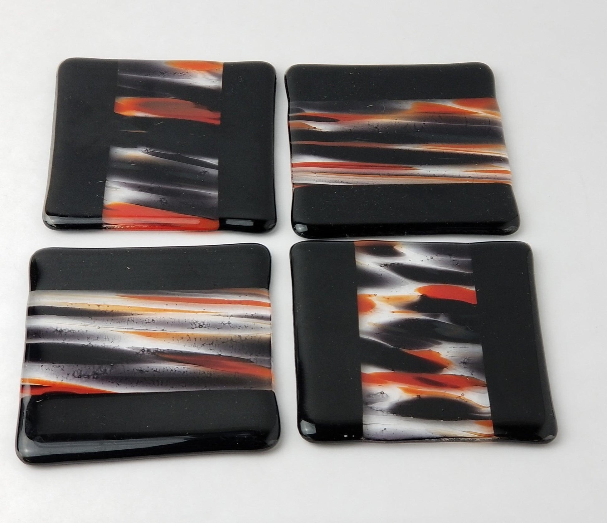 Black and red swirl fused glass coasters, set of 4. From Seeds Glassworks, seedsglassworks